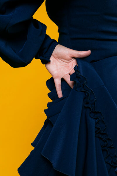 close-up-elegant-hand-with-orange-background-400×600